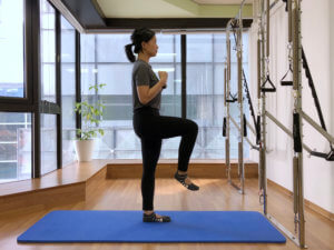 12a Standing knee tuck 300x225 1